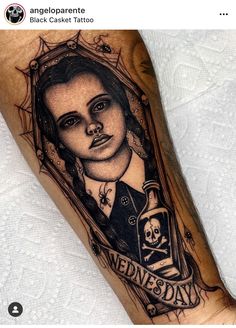 a woman's leg with a tattoo on it and a skull in the middle