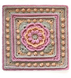 a crocheted square with a flower in the center