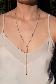 "\" JLO \" Spice up any outfit by throwing on this long Y lariat. This gorgeous chain pairs beautifully with a monochromatic outfit or a low v cut shirt. L E T S . T A L K . N E C K L A C E S ✤ Available in 14k Gold Filled or Sterling Silver ✤ Model is wearing size 36\" ✤ A bead is added where the \"Y\" meets as an adjustable slider stopper. (The bead is movable up down for a versatile look!) ✤ Available sizes 28\" 32\" 36\" All purchased items will arrive in a Tommassini Jewelry box. If you pur Clavicle Chain Y-shape Drop Necklace, Lariat Backdrop Necklace As Gift, Adjustable Lariat Backdrop Necklace, Minimalist Party Lariat Drop Necklace, Minimalist Lariat Drop Necklace For Party, Adjustable Lariat Drop Necklace, Dainty Lariat Body Chain As Gift, Minimalist Lariat Necklace For Party, Bohemian Lariat Necklace With Dangle For Party