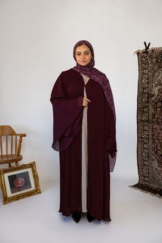 Our new pleated abaya will make you feel like twirling. In a rich burgundy, it’s pleated throughout in soft flowy fabric. Complete the look with our black or beige layering dress or rock it alone. Pairs with Berry Mosaic Sarah 5’4 M/L Standard (was wearing 2 inch heels) Mariam S/M 5’7 Tall (was wearing 2 inch kitten heels) Wafaa 5’1 S/M Short (was wearing 1 inch platforms). Hijab Colors, Grey Sweats, Hijab Styles, Flowy Fabric, Rich Burgundy, Layer Dress, Modest Fashion Outfits, Abaya Fashion, Midnight Navy