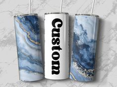 two personalized tumblers with the word coast on them are shown against a marble background