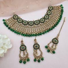 'SANAM' Bridal Diamond Polki necklace set  This necklace is a unique blend of bold and classy! Made with fine Diamond Polki on the highest quality brass as the base metal. Delicate necklace accented with emerald green color beads. This necklace comes with matching earrings and Maang tikka. Necklace witdh 6cmm Earrings and tikka L6cm approx Step into the world of high fashion and luxury with this statement piece. Bollywood Green Tikka With Stone Work, Elegant Green Kundan Tikka, Green Bollywood Meenakari Jewelry Sets, Bollywood Green Tilla Necklace, Pakistani Jewelry Bridal, Bollywood Style Green Gold-plated Necklace, Necklace Set With Earrings, Stone Necklace Set, Jewelry Pakistani