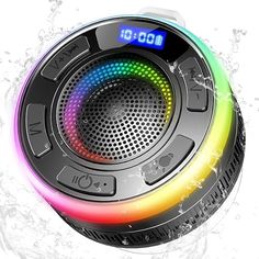 an image of a colorful speaker with water splashing on it's side and the time displayed