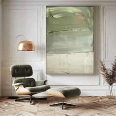 an abstract painting hangs in the corner of a living room with a chair and ottoman