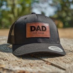 Get the perfect new dad, baby announcement, or father's day gift! Made with real leather patches and then engraved and stitched to one of our trucker snapback hats.  We can engrave any name or text on the patch such as: Dad, Daddy, Papa, Grandpa, etc.  Just add in the personalization box the text and year (if any) that you'd like engraved on the patch. Product Details: - Handcrafted, engraved, and stitched in Portland, OR - Each patch is hand-dyed and made to order from premium veg-tanned leather hides. - Patches available in Brown, Black, or Tan - Patches are permanently stitched to the hat to make sure they last and hold up well over time! - We use YP 6006 Classic Trucker Hats available in a number of colors.  - The patch size is: 3in x 1.8in Ordering is Simple:  Select the hat color, pa Dad Baby Announcement, New Dad Gift, Leather Hides, Dad Baby, Gifts For New Dads, Leather Hide, New Dads, Dad Hat, Leather Patches