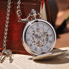 DESCRIPTION: This Silver Full Hunter Pocket Watch is a classic design for anyone to appreciate. The cover is intricately designed with a subtle interlocking pattern and room for engraving personal initials, making it the perfect gift for any occasion. The crystal face and back cover brilliantly showcases the skeleton and mechanics of the clock's inner workings, giving it an antique feel that any pocket watch lover would enjoy. A Full Hunter Pocket Watch is a classic style that includes a pocket Stainless Steel Pocket Watch With Skeleton Dial For Gift, Timeless Skeleton Dial Pocket Watch As Gift, Silver Timeless Watch For Everyday Use, Silver Timeless Watches For Everyday Use, Silver Everyday Timeless Watch, Silver Stainless Steel Pocket Watch, Silver Timeless Watch, Elegant Stainless Steel Pocket Watch With Metal Dial, Silver Watch With Metal Dial For Everyday Use