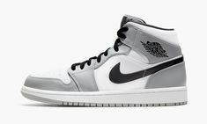 The Air Jordan 1 Mid “Light Smoke Grey” finds Michael Jordan’s first signature shoe in mid-top form in a shadowy, ultra versatile color scheme. The Jordan 1 Mid has gained popularity in sneaker culture for its unique mid-top shape and range of desirable colorways. Both aspects come into play on the “Light Smoke Grey” colorway. White leather forms the base of the upper, appearing on the perforated toe, mid-panel, and collar. Light Smoke Grey leather overlays can be found on the forefoot, eyelets, Air Jordan 1 Mid Grey, Sepatu Air Jordan, Retro Jordans, Grey Man, Grey Jordans, Nike Fashion Shoes, Jordan Shoes Girls, Nike Air Shoes, Air Jordan Retro