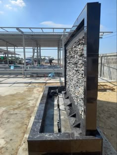 an outdoor fountain in the middle of a construction site with lots of rocks on it