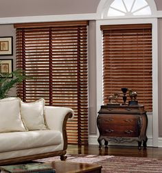 a living room with wooden blinds and furniture