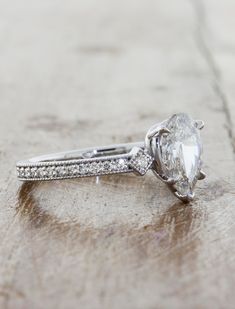 Charleen is a work of love and art. She oozes vintage flair that is hard to resist. Charleen holds a glorious pear shape center diamond that commands attention with her unique position. The diamond is nestled in between 0.18tcw of brilliant round white diamonds that act as her companion much like her future partner will forever and ever. Width of band is approximately 2mm. Drop-down diamond options represent our recommended grade, which maximizes size for value, while maintaining eye-perfect cla Future Partner, Pear Diamond Engagement Ring, Lab Diamond Engagement Ring, Curved Wedding Band, Rose Engagement Ring, Yellow Gold Setting, Rose Gold Engagement, Pear Shaped Diamond, Pear Diamond