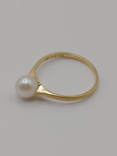 An absolutely stunning 18 carat gold and pearl ring by Ceson of Gothenburg, Sweden and made in 1996. The ring is in excellent condition. It is fully hallmarked K & EC for Ceson,  G for the town mark of Gothenburg,  cat paw, 18 k for 18 carat gold and X10 for the year 1996.  Measurements UK ring size N Weight 2 grams Classic Pearl Drop Ring, Classic Gold Pearl Ring For Anniversary, Classic Yellow Gold Rings With Pearl Drop, Classic Oval High Luster Ring, Classic Oval Rings With High Luster, Classic Oval Ring With High Luster, Classic Gold Pearl Drop Ring, 14k Gold Pearl Ring With High Luster, 14k Yellow Gold High Luster Pearl Ring