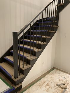 an empty room with some stairs in the middle and blue carpet on the floor next to it