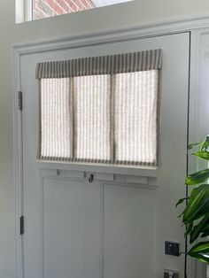 We are proud to say this product is custom made in the USA; made with care, using a high-quality, hand-picked fabric.   Enjoy convenience and style with our Small Front Door or Sidelight Curtains. Designed for ease of use, simply fold or roll up in seconds. These curtains are more than just entryway coverings; they elevate your space. With no cords or holes, installation is a breeze, requiring only our provided Adhesive Hook & Loop Fastener strip, eliminating the need for hardware, putting no holes in your door. Fabric Description and Content: This Taupe Striped Fabric is a medium weight and very soft. The background color is a beige, creamy oatmeal color and the stripe is a grayish tan color. This fabric allows a lot of light through, but still gives full privacy, even at night. Made from Front Door Window Valance, Mobile Home Door Window Curtain, Front Door Side Window Blinds, Laundry Door Curtain, Mini Blinds For Front Door, Fabric Door Covers, Front Door Roll Up Shade, Small Patio Door Coverings, Door Small Window Treatments