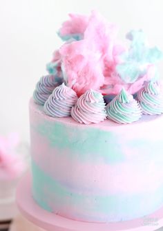 a pink and blue cake with frosting on top