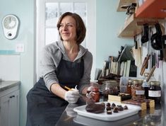 a woman sitting at a counter in a kitchen