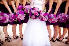 a bride and her bridals with purple bouquets in front of the color scheme