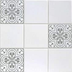 a white and grey tile pattern on the wall