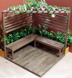 a wooden bench sitting in the middle of a garden with plants growing on it's sides