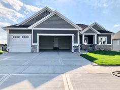 a large house with two garages on the front and one attached to the back