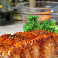 some meat and broccoli on a plate with sauce in the middle for garnish