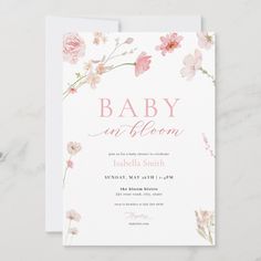 a baby is bloom card with pink flowers on the front and bottom, in watercolor