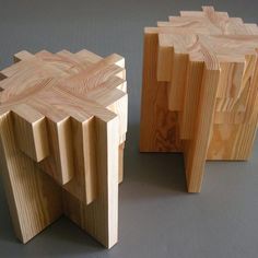 two pieces of wood sitting next to each other on top of a gray surface,