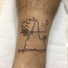 a man's foot with a small map tattoo on the side of his leg