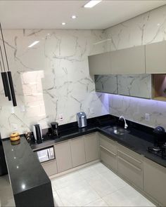 a kitchen with marble counter tops and black counters