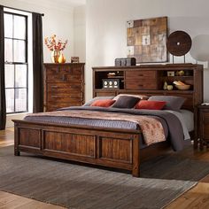 a bedroom with a bed, dressers and drawers in it's center area