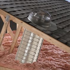 a roof that has been gutted and covered in pink stuff with a light on top