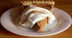 a slice of pumpkin pie with whipped cream on top