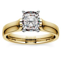 a yellow gold engagement ring with a cushion cut diamond