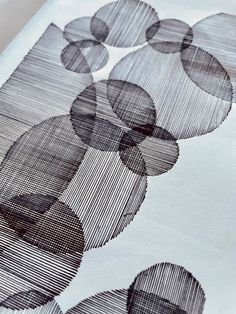 a close up view of an art work with circles and lines on white paper,