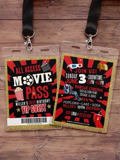 two luggage tags with movie tickets attached to them on a wooden surface, one has a black ribbon and the other has gold glitter