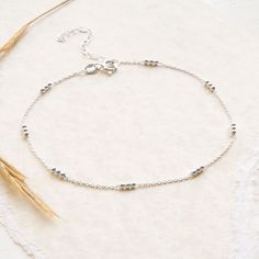 "Add some summer warmth to your look with our deliciously delicate Sterling Silver Triple Ball Anklet This wonderful sterling silver anklet looks great regardless of the season It's design features groups of three silver balls spaces along a fine belcher chain and can be worn at lengths from 9\" to 11\" So why not add it to you collection and make everyday a summers day, even when it's raining All of our jewellery comes in a gift box with a blank gift card for you to write a short message on Made from: Sterling silver Dimensions: 0.1cm thick, 9\" to 10\"" Dainty Sterling Silver Anklets For Summer, Silver Elegant Anklets For Everyday Wear, Elegant Silver Anklets For Everyday, Silver Minimalist Anklets For Everyday, Minimalist Hypoallergenic Sterling Silver Anklets, Hypoallergenic Silver Bracelets For Summer, Summer Silver Bracelets With Tiny Beads, Silver Minimalist Bracelets For Summer, Minimalist Silver Bracelet For Summer