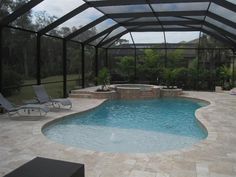 a swimming pool with an enclosed patio and hot tub