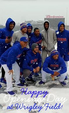 a group of baseball players standing in the snow