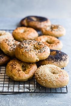 several bagels on a cooling rack with sesame seeds