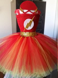 a red and yellow tutu dress with a gold lightning bolt on the front, as seen on instagram