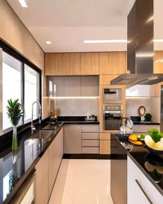 a modern kitchen with stainless steel appliances and black counter tops