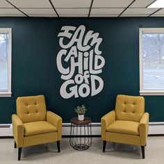 two yellow chairs in front of a wall with the words can child god on it