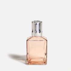 a bottle of perfume sitting on top of a white surface