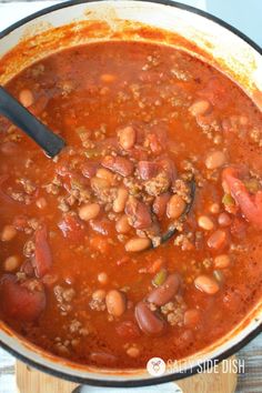 a pot filled with chili and beans on top of a stove