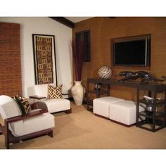 a living room filled with furniture and a flat screen tv mounted to the side of a wall