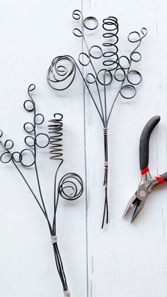 some scissors and wire on a white table