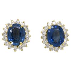 Blue Sapphire and 1.60CTW Round Brilliant Cut diamond halo style earrings in yellow gold. Gemstone: Blue Sapphire & Diamond Gemstone Carat Weight: Two Approximately 9.7x7.8mm Blue Sapphires Diamond Carat Weight: Approximately 1.60CTW Diamond Cut: Round Brilliant Cut Color: Average G-I Clarity: Average VS-SI Metal: 18K Yellow Gold Earrings with 14K Yellow Gold Posts and Backs Marked/Tested: Backs and Posts Stamped "14K”and earring baskets tested 18K Weight: 5.5 Grams Earring Length: Approximately Luxury Sapphire Round Cut Earrings, Luxury Sapphire Jewelry Round Cut, Luxury Sapphire Earrings With Polished Finish, Luxury Sapphire Diamond Earrings With Round Cut, Luxury Sapphire Diamond Earrings In Classic Style, Luxury Round Sapphire Diamond Earrings, Luxury Sapphire Diamond Earrings For Formal Occasions, Luxury Blue Brilliant Cut Diamond Earrings, Luxury Sapphire Earrings With Prong Setting