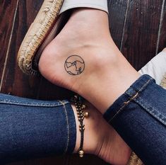 a woman's foot with a small tattoo on the side of her leg and ankle