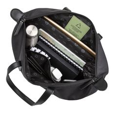 an open black bag with various items in it on a white background, including pens and pencils