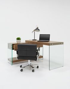 a desk with a chair and a laptop on it