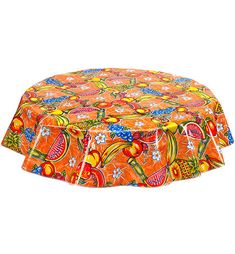 an orange round tablecloth with colorful designs on the top and bottom, sitting in front of a white background